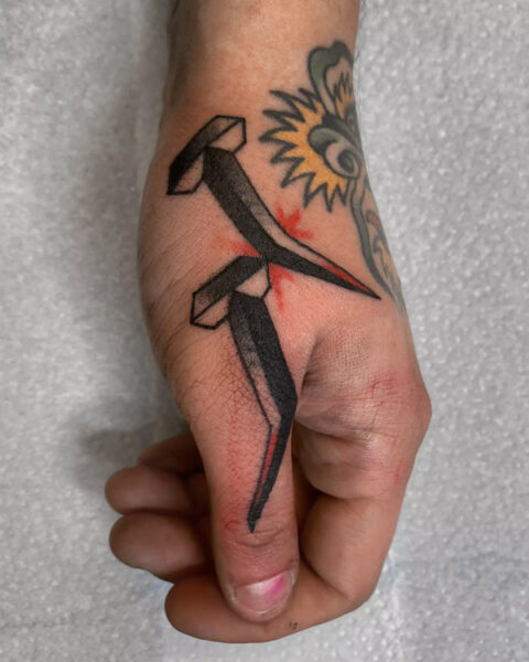 Classic nail tattoo design by Alan Crisogano One Love Tattoo Prague